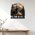 Bear mountain wall decor displayed on a white paneled wall above a rustic console table