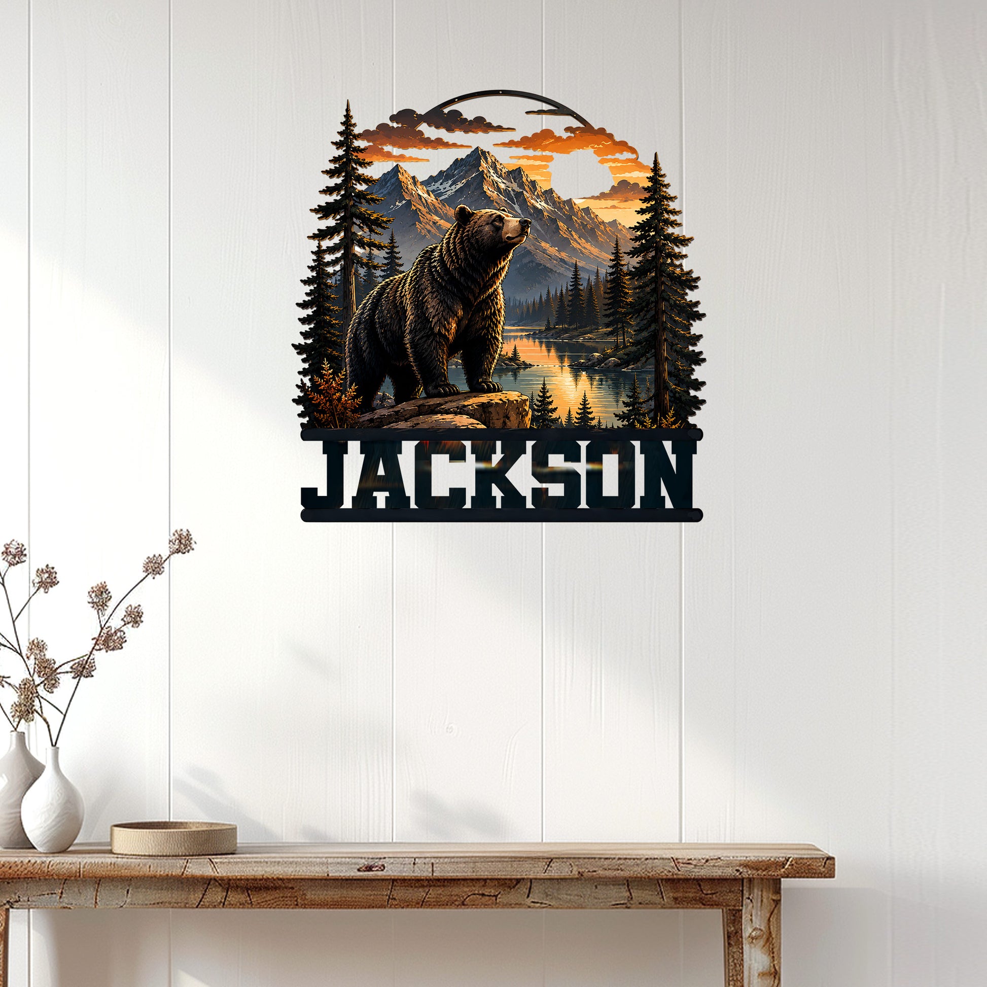 Bear mountain wall decor displayed on a white paneled wall above a rustic console table