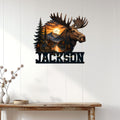 Moose wall sign displayed on a light wood-paneled wall above a rustic console table