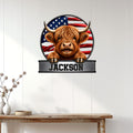 Highland cow patriotic metal wall sign displayed on a white wood-paneled wall above a console table