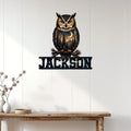 Owl wall decor displayed on a white paneled wall above a rustic console table