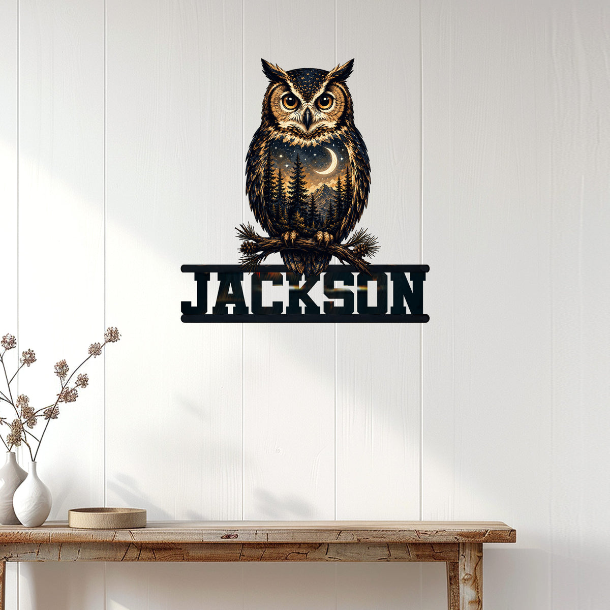 Owl wall decor displayed on a white paneled wall above a rustic console table