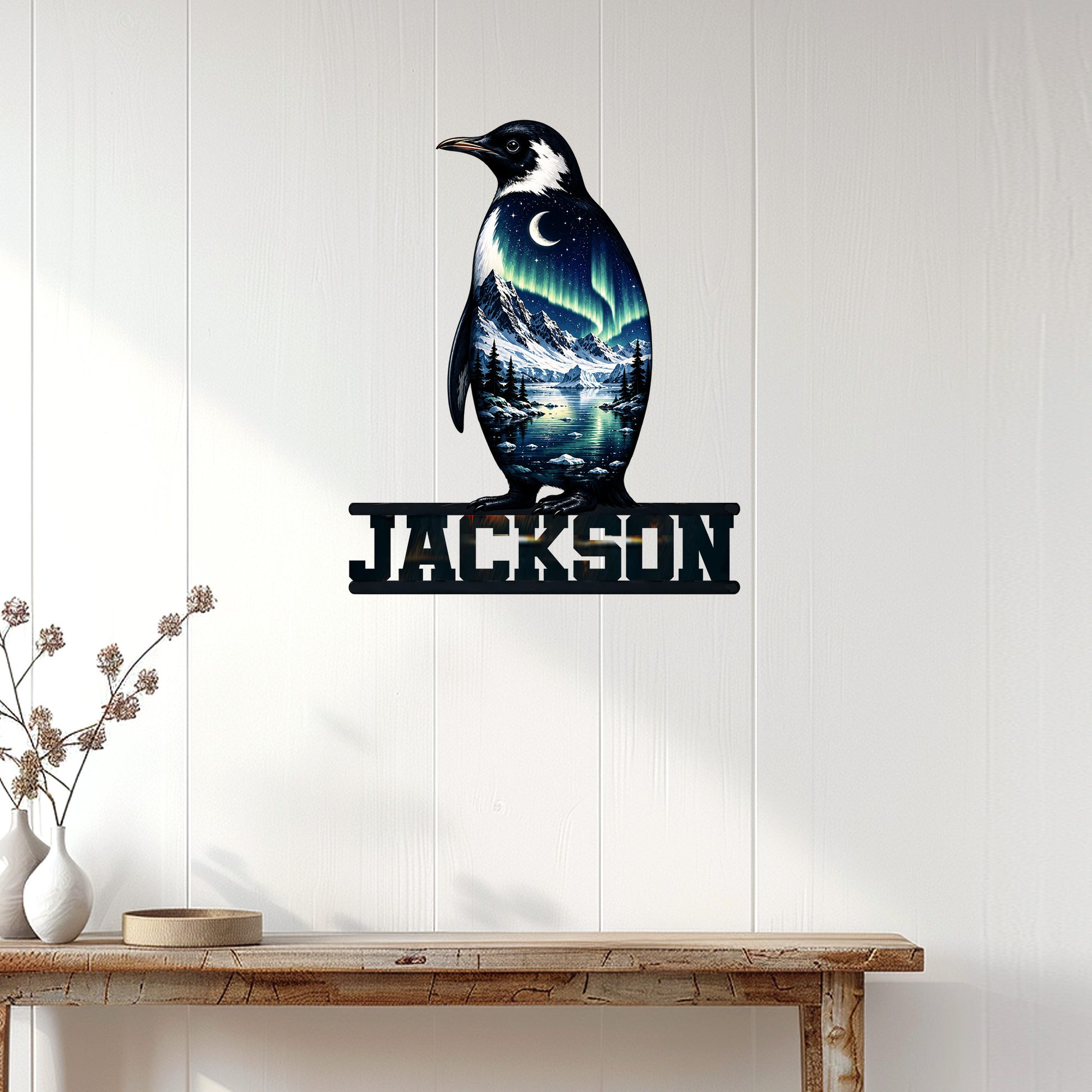 Penguin wall sign displayed on white paneled walls above a console table in a modern home