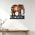 Elephant savanna metal wall sign displayed on a light paneled wall above a rustic console table
