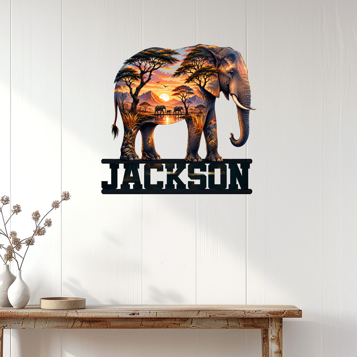 Elephant savanna metal wall sign displayed on a light paneled wall above a rustic console table
