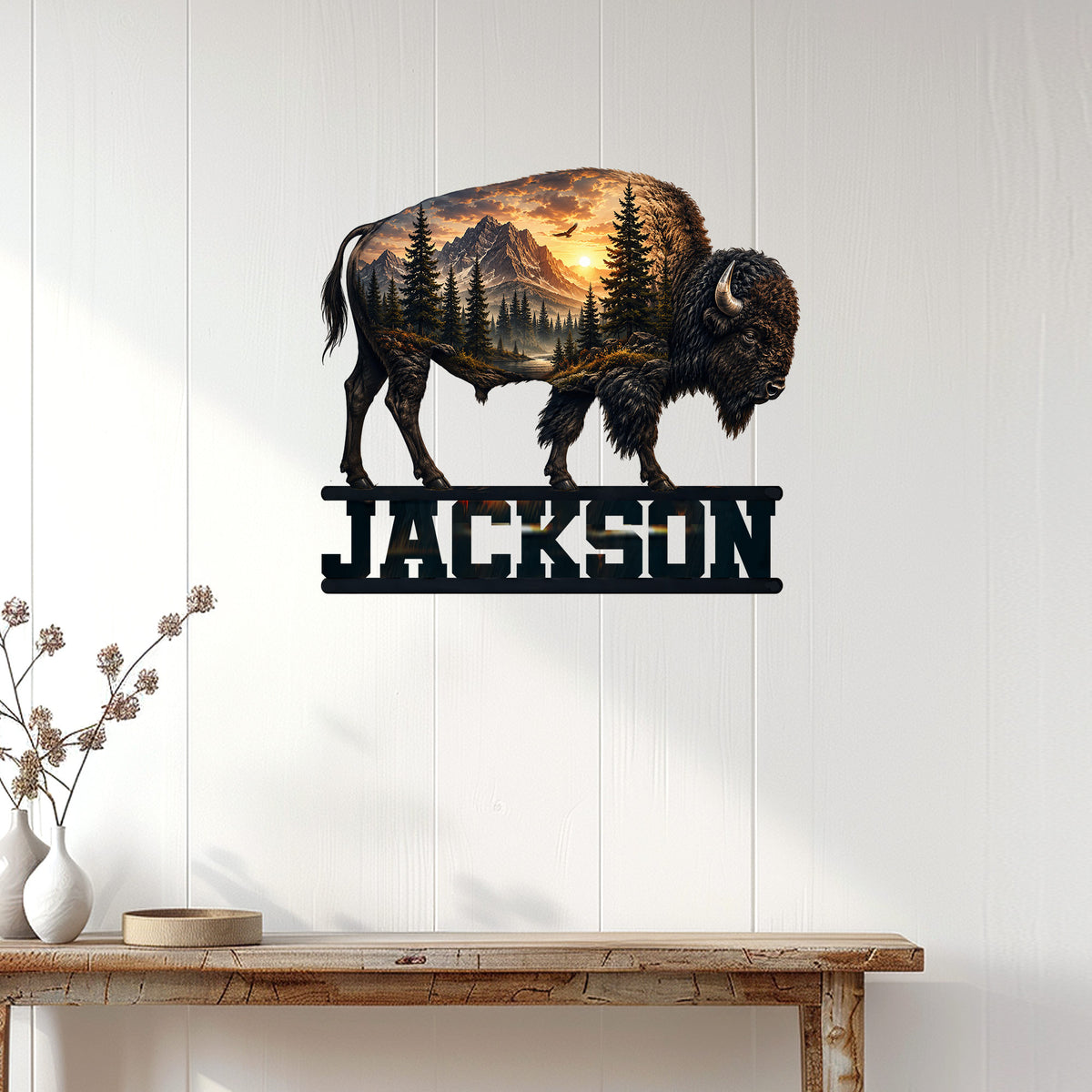 Bison metal wall sign displayed on a light wood-paneled wall above a rustic console table