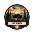 Custom bison metal sign featuring a buffalo in a mountain forest landscape at sunset