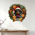 Christmas dachshund wall sign displayed on a white paneled wall above a console table