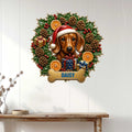 Christmas dachshund wall sign displayed on a light paneled wall above a console table