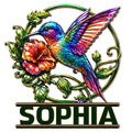 Colorful hummingbird metal sign with raised wings, tropical flower, curling vines, and vibrant jewel-toned details
