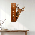 Rustic deer hunting wall sign displayed on a white paneled wall above a console table