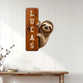 Sloth metal wall sign displayed on white paneled walls above a rustic console table