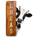 Custom cow metal sign featuring a curious black-and-white cow peeking around a rustic wood-look panel