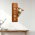 Sheep farmhouse wall sign displayed on white paneling above a console table