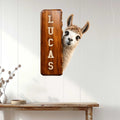 Custom llama metal sign displayed on a white paneled wall above a console table