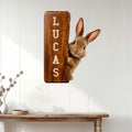 Rabbit metal wall sign displayed on a white paneled wall above a console table