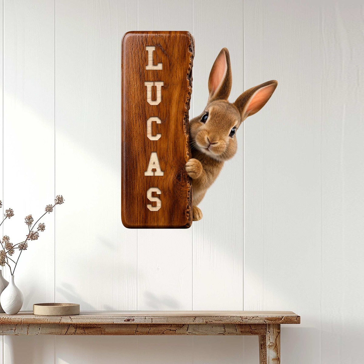Rabbit metal wall sign displayed on a white paneled wall above a console table