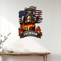 Firefighter metal wall sign displayed on a light paneled wall, featuring a helmeted responder and patriotic flag backdrop