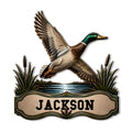 Detailed duck hunting metal sign featuring a flying mallard over pond water and cattails