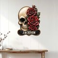 Gothic skull and rose metal wall sign displayed on a white paneled wall above a console table