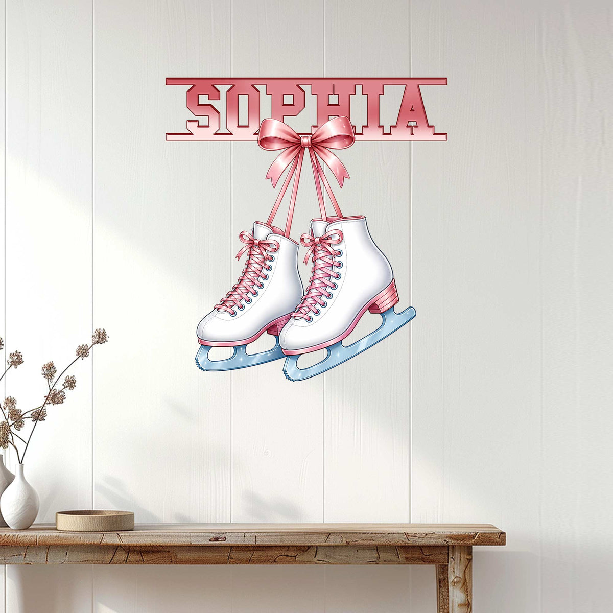 Pink and white ice skating wall sign displayed on a light wood-paneled wall above a console table
