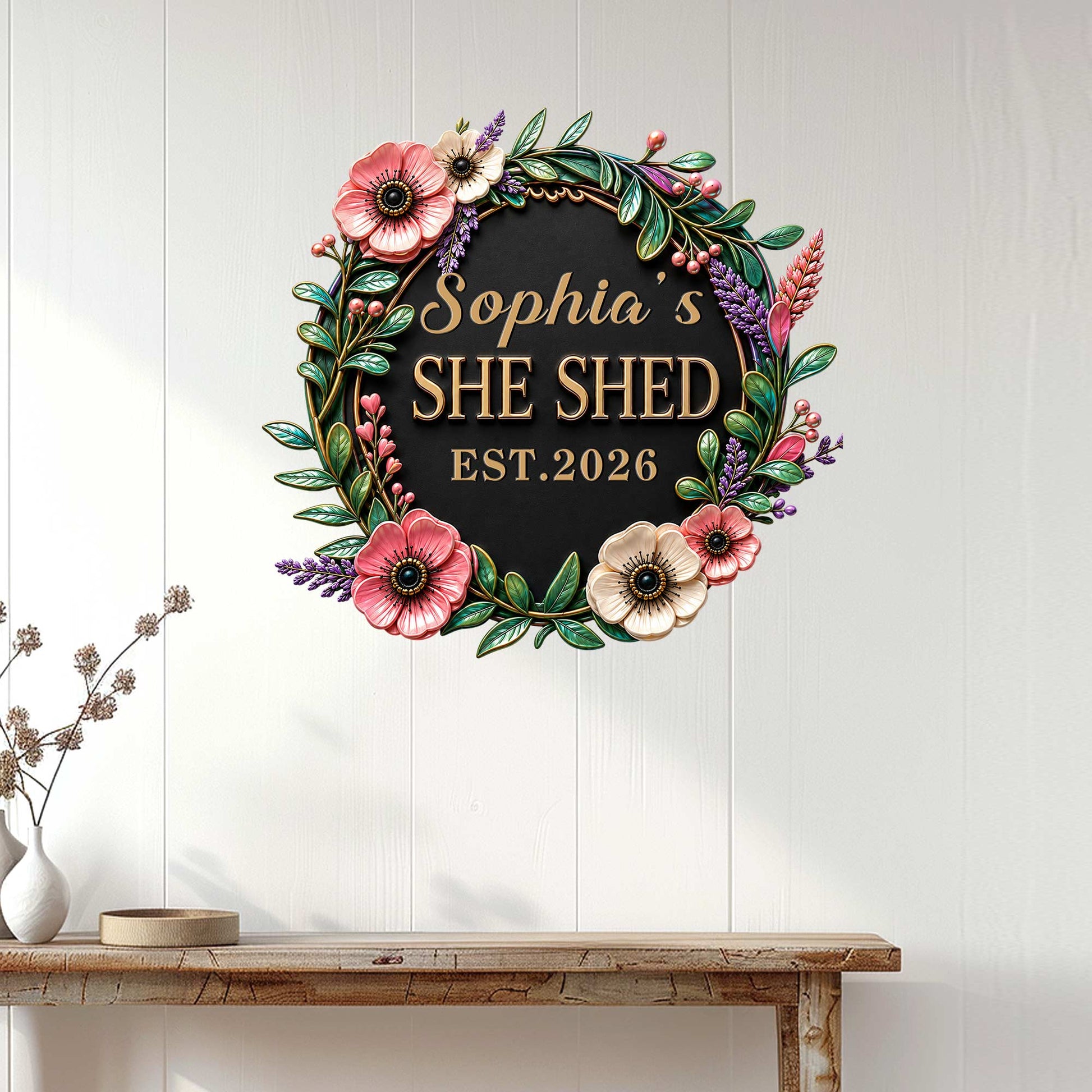 Floral She Shed wall sign displayed on a white paneled wall above a console table