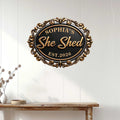 She Shed metal sign displayed on a white paneled wall above a console table