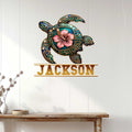 Decorative turtle metal wall sign displayed on a white paneled wall
