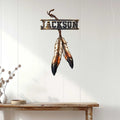 Native American-inspired feather dreamcatcher sign displayed on a bright paneled entryway wall