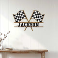 Checkered flag racing metal sign displayed on a bright wood-paneled wall above a console table