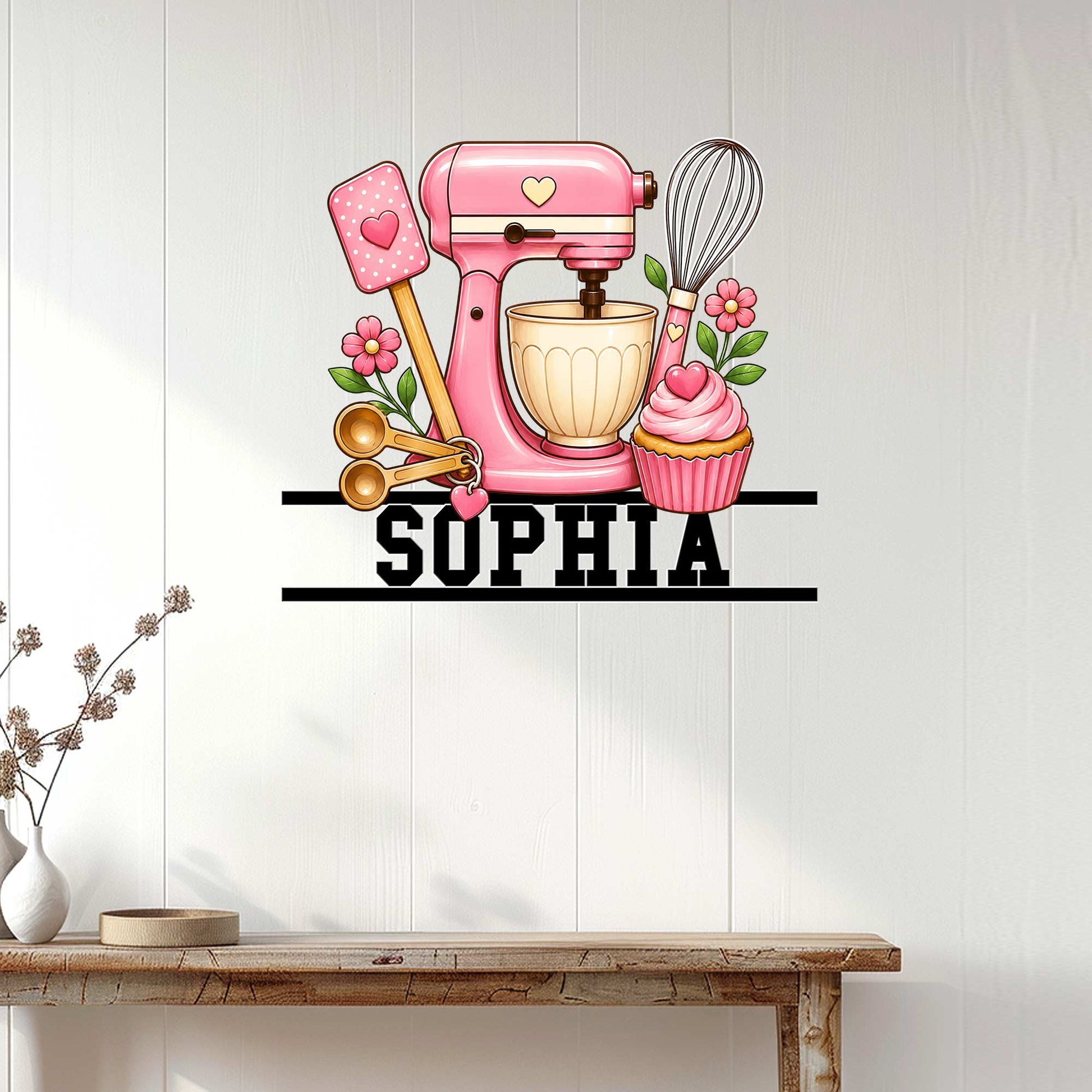 Baking wall decor displayed on a light wood wall above a console table with a pink mixer design