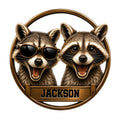 Custom raccoon metal sign featuring two cheerful raccoons in a circular bronze frame, including one wearing sunglasses