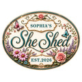 Ornate oval She Shed metal sign with butterflies, roses, wildflowers, and elegant script design
