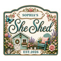 Floral She Shed metal sign featuring a garden retreat, butterfly, Adirondack chair, flowers, and watering can