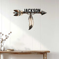 Native American-inspired arrow wall sign displayed above a console table in a bright modern home