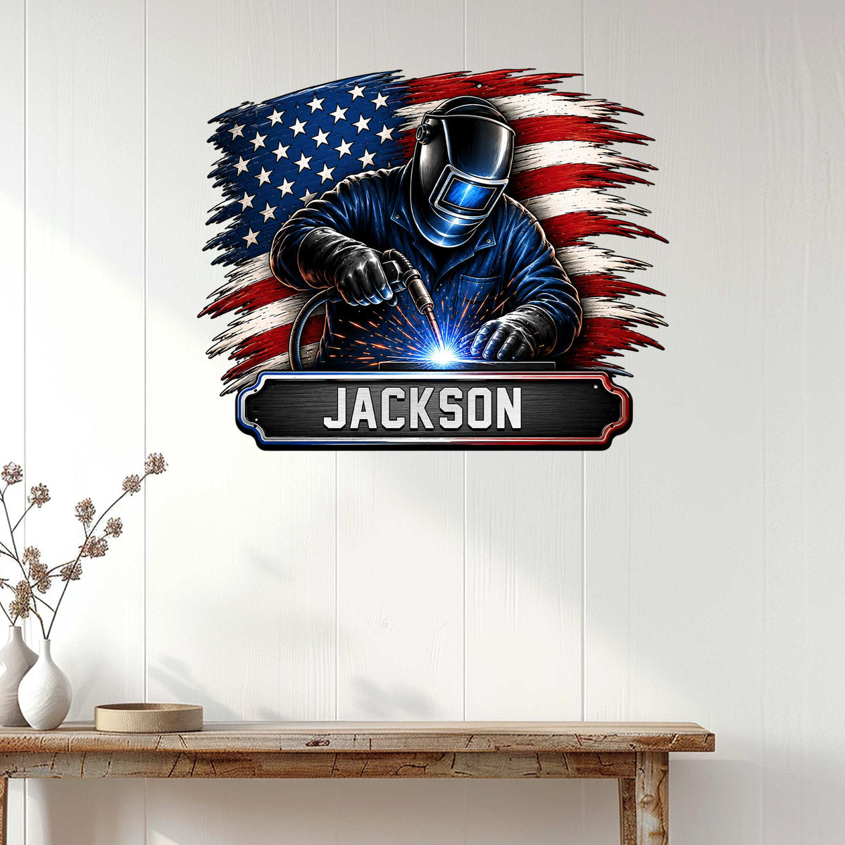 Welder wall sign displayed on a white paneled wall above a rustic console table