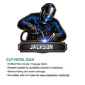 Welder metal sign product graphic showing a helmeted worker using a welding torch with sparks and a bold industrial plaque design