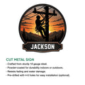 Lineman metal sign featuring a climbing utility worker, power lines, mountains, and sunset artwork