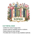 Book-themed cut metal sign with illustrated books surrounded by pink, blue, and purple flowers