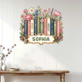 Floral bookshelf metal sign displayed as wall decor above a console table in a bright home
