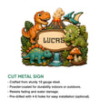 Dinosaur metal sign with a playful prehistoric scene, leafy jungle details, and a framed central design