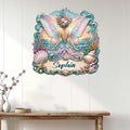 Ocean fairy wall decor displayed on a light wood wall, featuring pastel wings, seashells, coral, and coastal waves
