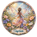Ornate fairy metal sign featuring a winged woman surrounded by colorful flowers and an enchanted garden landscape
