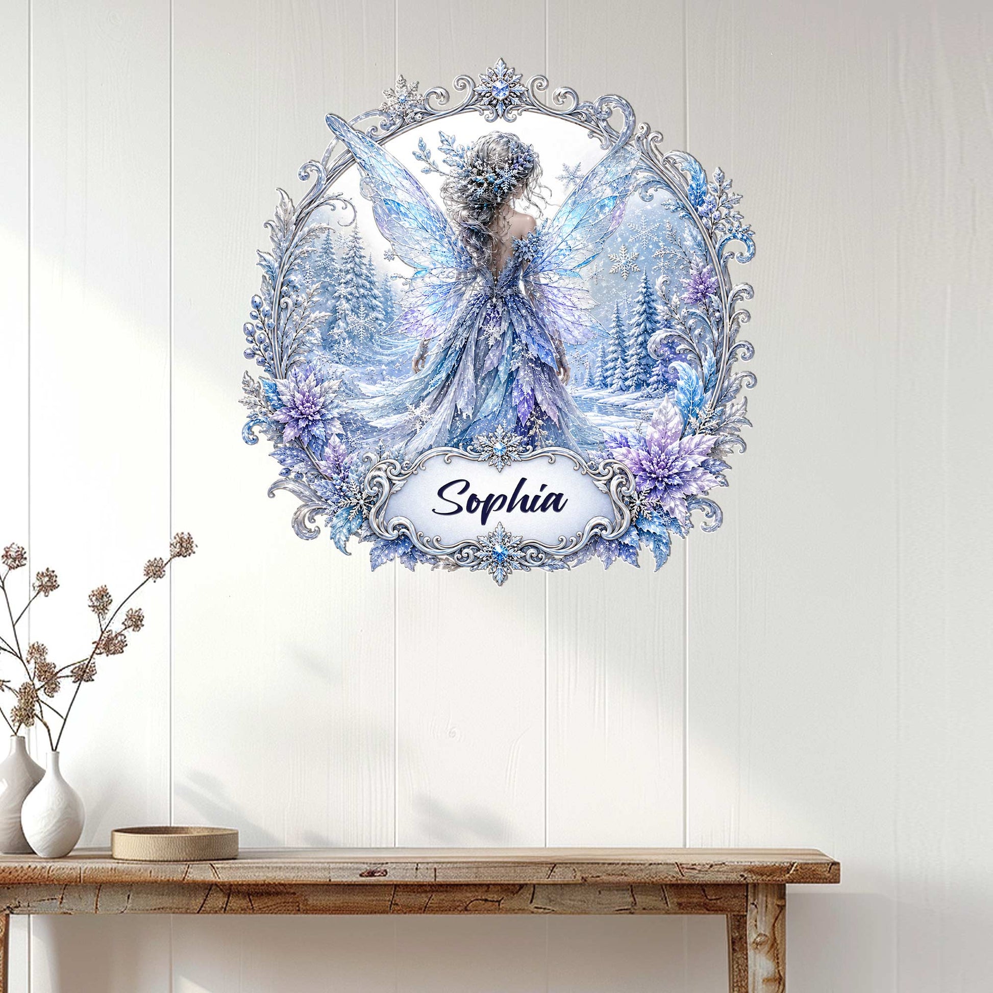 Winter fairy wall sign displayed on a light wood-paneled wall above a console table