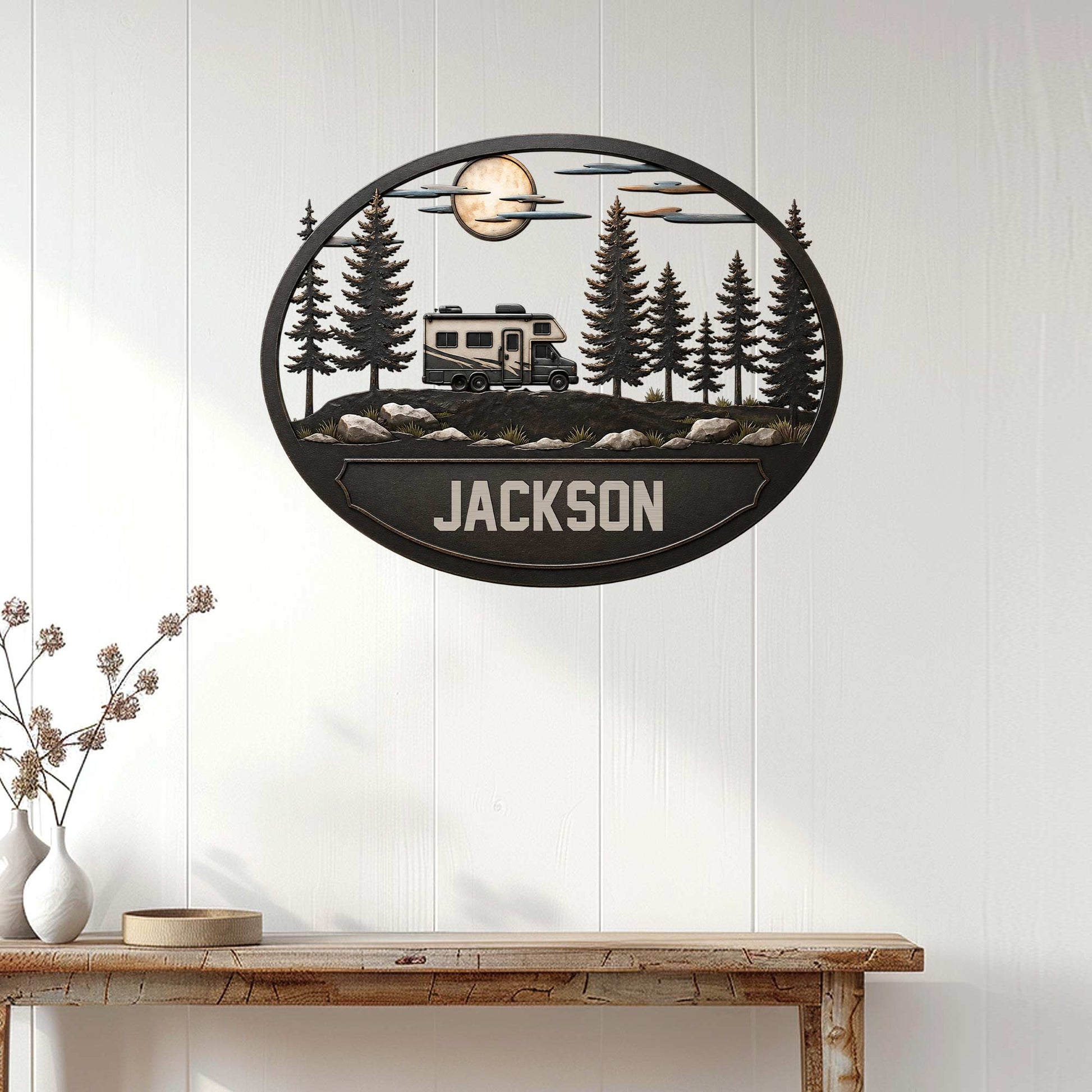 RV camping wall decor displayed on a white paneled wall, featuring a camper surrounded by pine trees at night