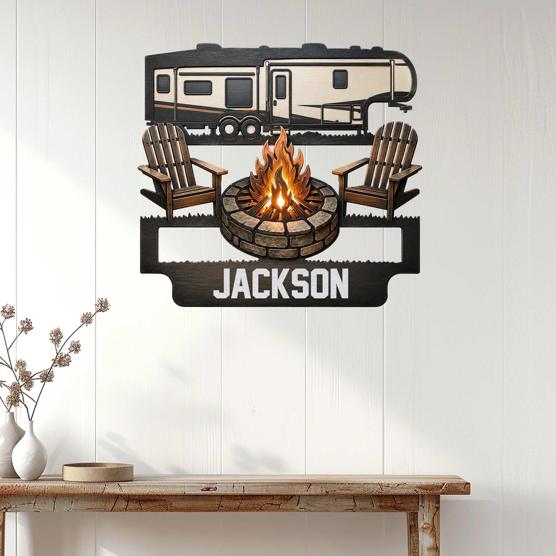 Camping wall decor displayed on a white paneled wall, featuring an RV, campfire, and Adirondack chairs
