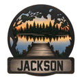 Custom lake house metal sign featuring a dock leading to a pine forest lake at sunset