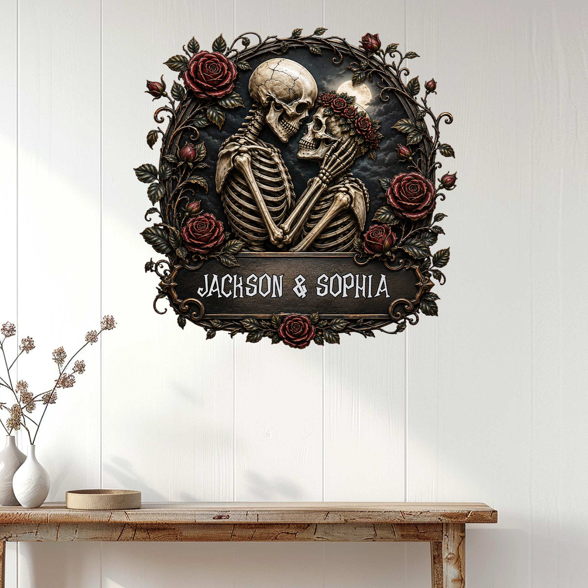 Gothic skeleton couple wall sign displayed on white wood paneling above a console table