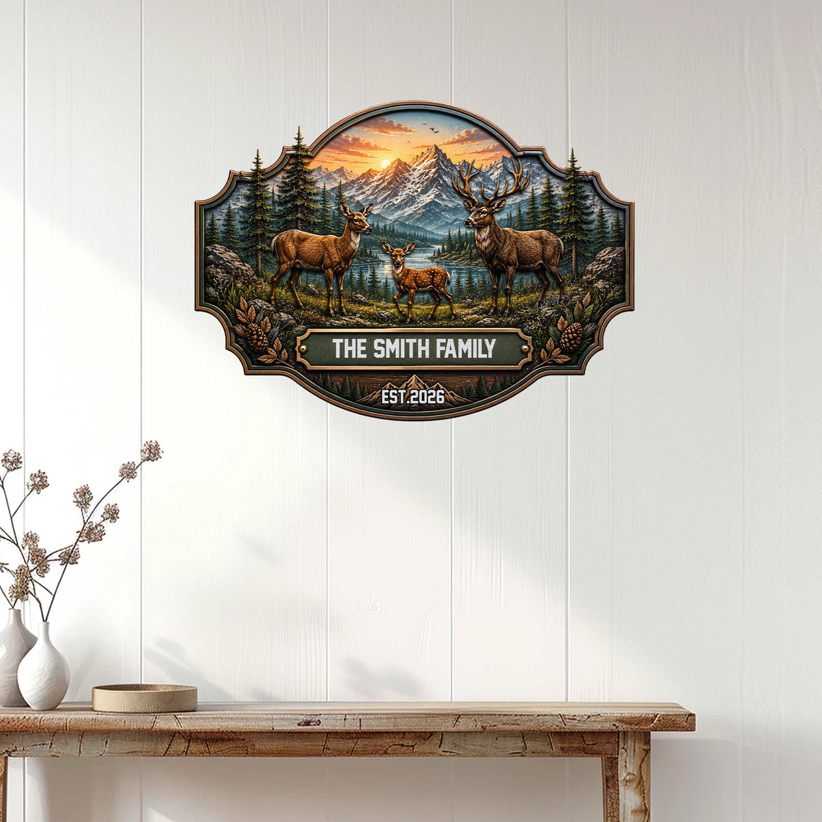 Rustic deer family metal sign displayed on a white paneled wall above a console table