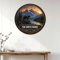 Bear wall sign displayed on a white paneled wall above a rustic console table